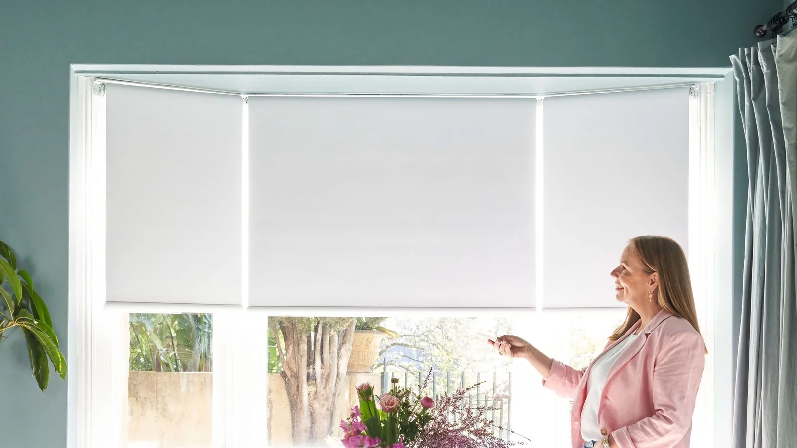 Motorised roller blinds operated by remote in a bay window