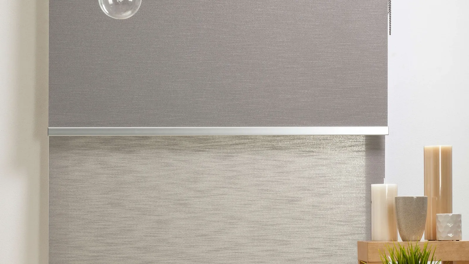Dual roller blind pairing a blockout and a light-filtering fabric