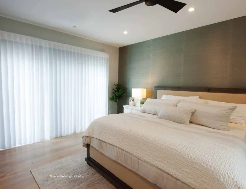 SmartDrape diffusing daylight over a king bed in a modern bedroom
