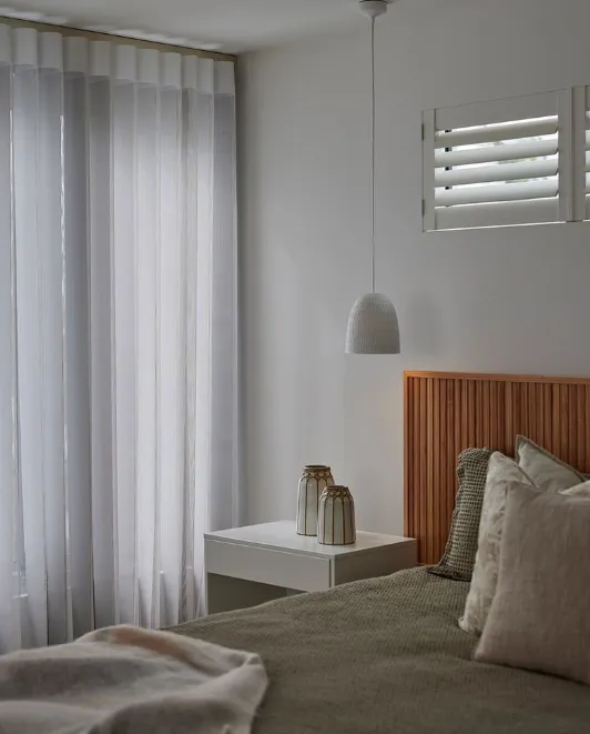 SmartDrape sheers beside a timber bedhead in a coastal-style bedroom