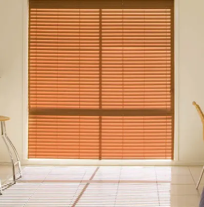Timber venetian blinds over a glass door