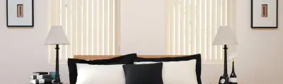 Fabric vertical blinds across wide bedroom windows